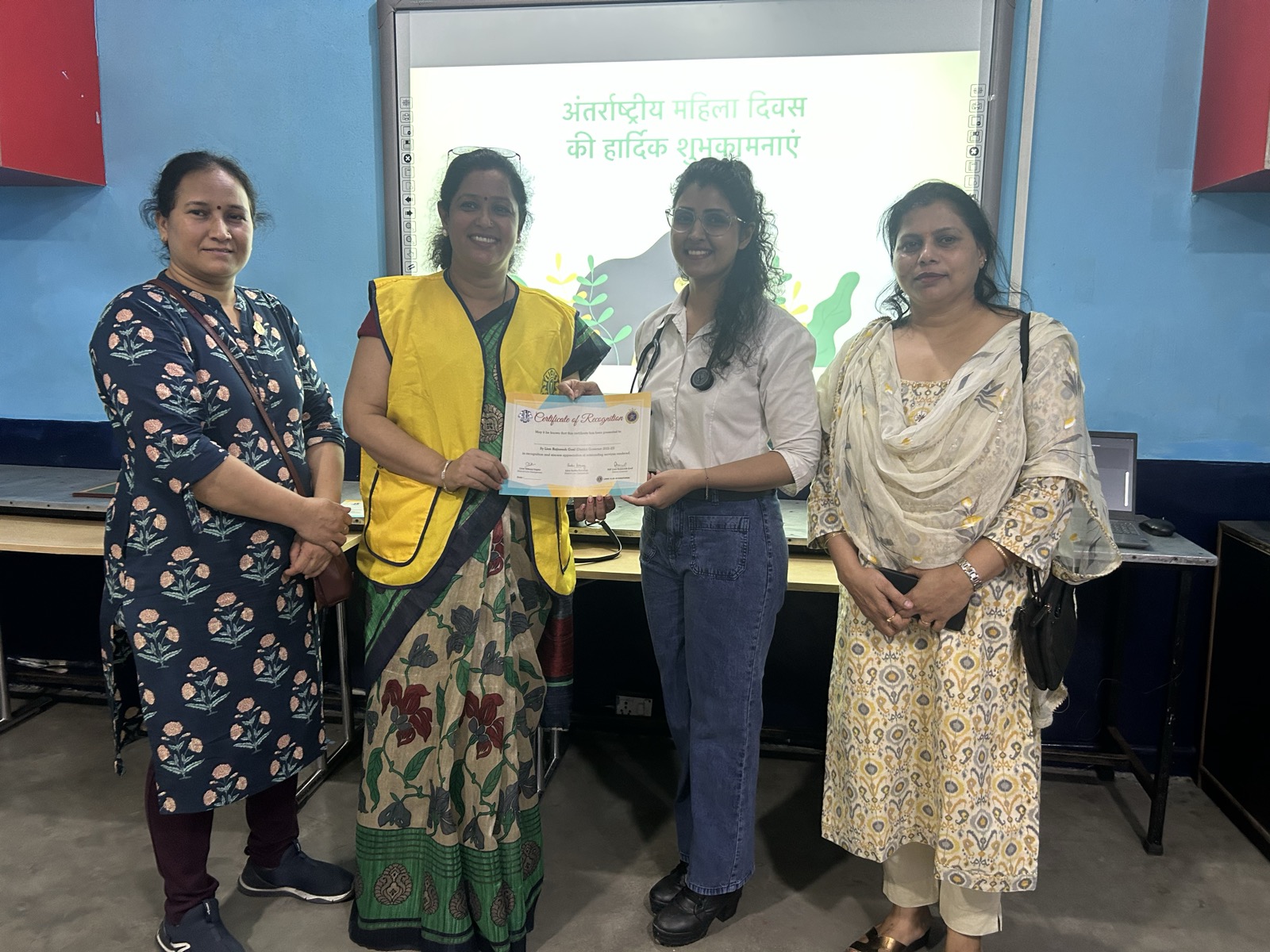 Dr. Sonal receiving an award certificate for community health work