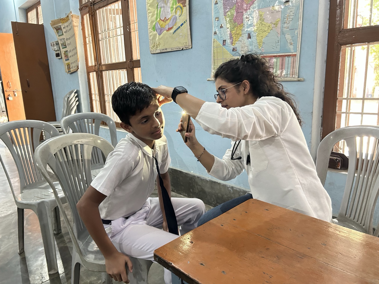 Doctor performing eye examination on a school student