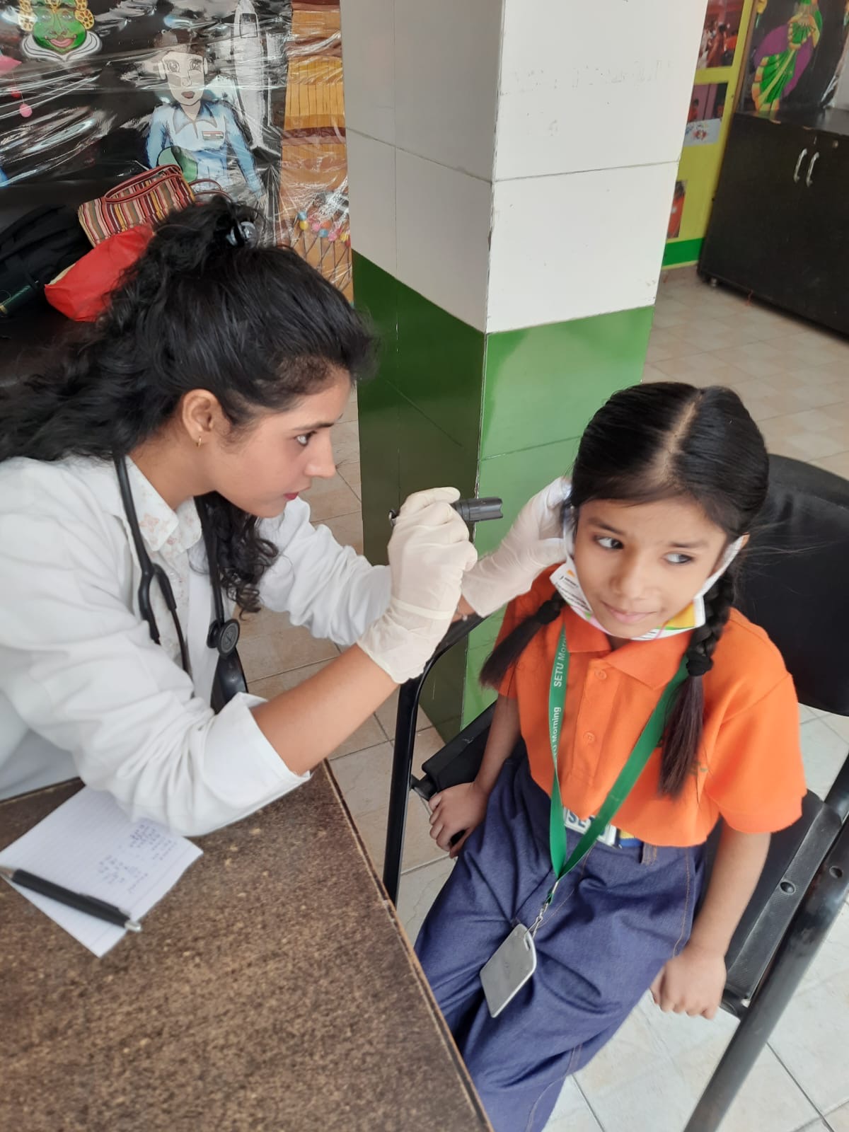 Dr. Sonal examining a schoolgirl during a free health checkup camp