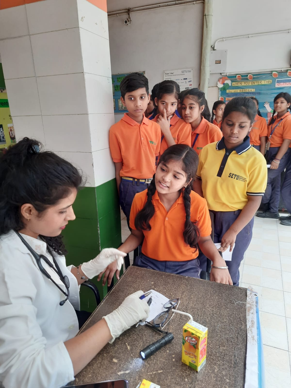 Dr. Sonal demonstrating medical screening to schoolchildren
