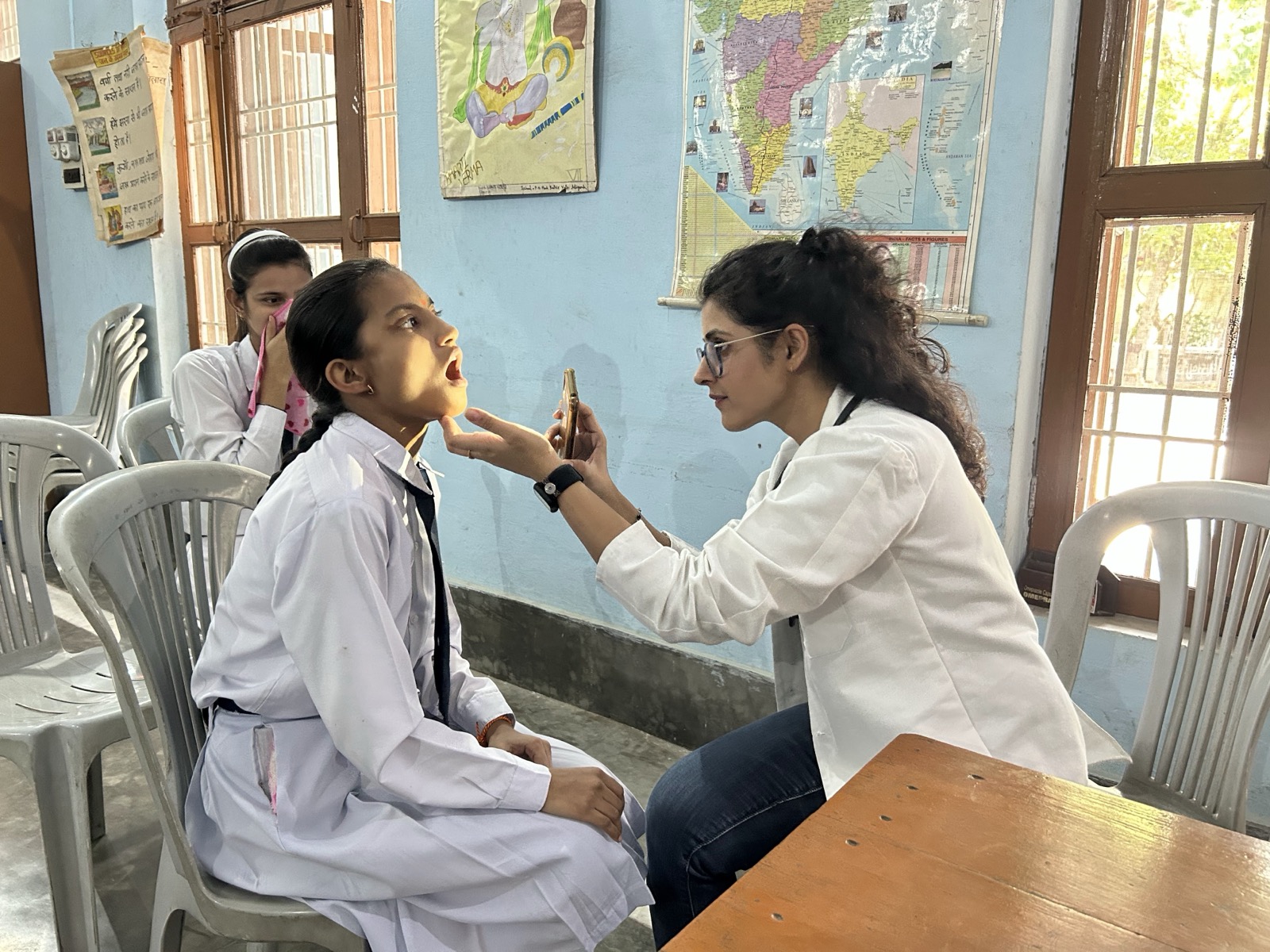 Doctor performing a thorough oral examination of a student